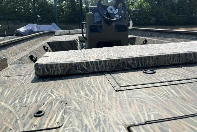 Slide: The Image of 2026 Tracker Grizzly 2072 CC boat with camouflage pattern and central console. - 6