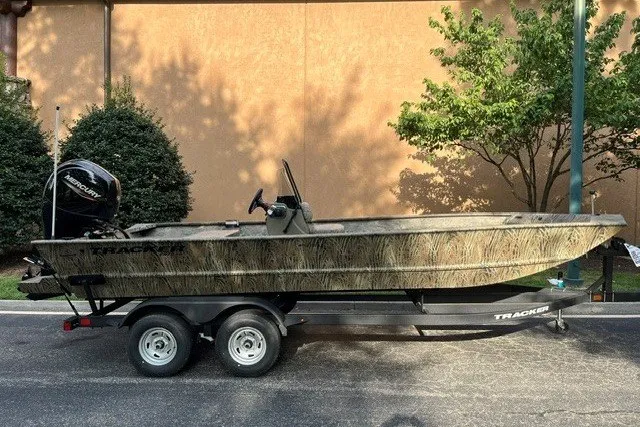 The Image of 2026 Tracker Grizzly 2072 CC boat on trailer, parked outdoors. - 0