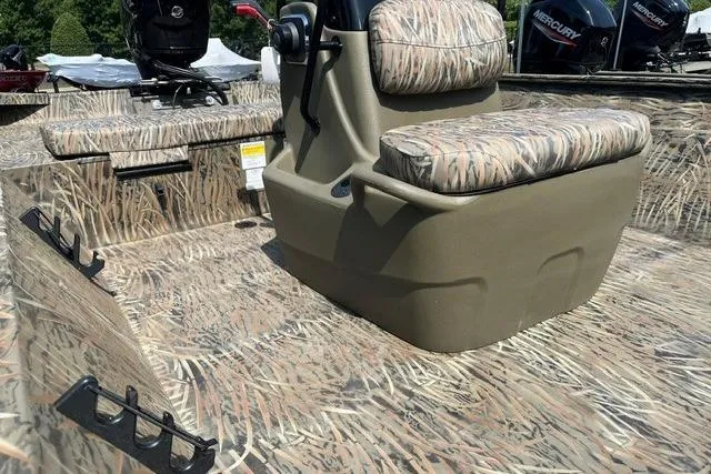 Slide: The Image of 2026 Tracker Grizzly 2072 CC boat interior with camo seating and console. - 8