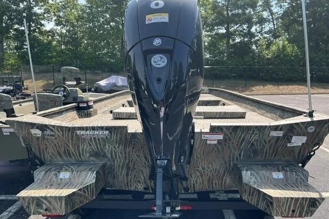 Slide: The Image of 2026 Tracker Grizzly 2072 CC boat with camouflage design and powerful outboard motor. - 5