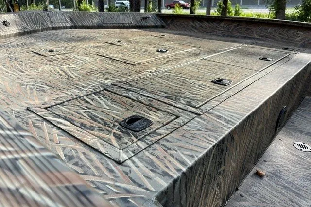 Slide: The Image of 2026 Tracker Grizzly 2072 CC boat deck with camo pattern and storage compartments. - 15