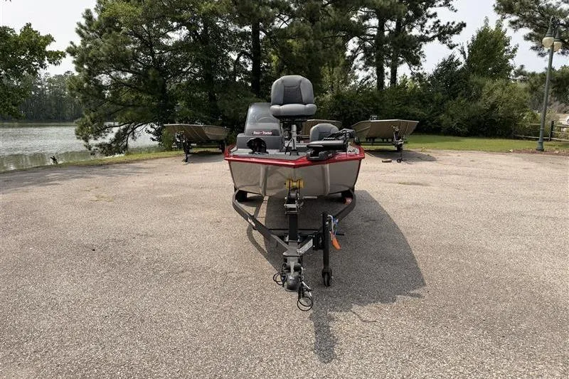 Slide: The Image of 2026 Tracker Bass Tracker Classic XL boat parked near a scenic lake. - 3