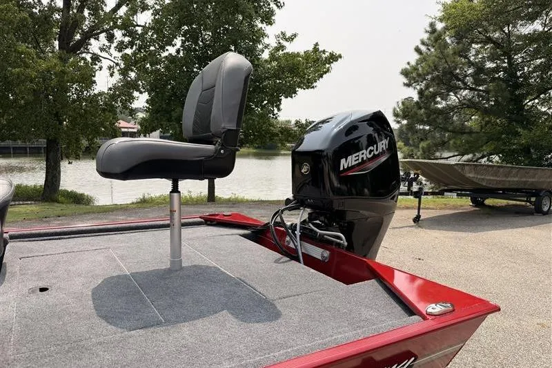 Slide: The Image of 2026 Tracker Bass Tracker Classic XL boat with Mercury engine by a lake. - 12