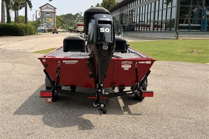 Slide: The Image of 2026 Tracker Bass Tracker Classic XL boat with Mercury 50 engine, parked outdoors. - 4