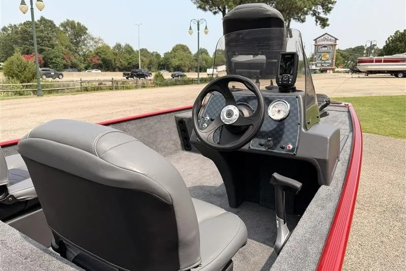 Slide: The Image of 2026 Tracker Bass Tracker Classic XL boat interior with steering wheel and dashboard controls. - 11
