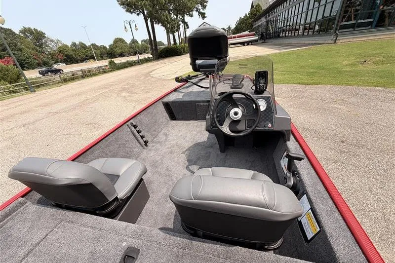 Slide: The Image of 2026 Tracker Bass Tracker Classic XL boat interior with steering console and seating. - 9