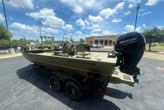 Slide: The Image of 2026 Tracker Grizzly 2072 CC Sportsman boat with Mercury engine in parking lot. - 3