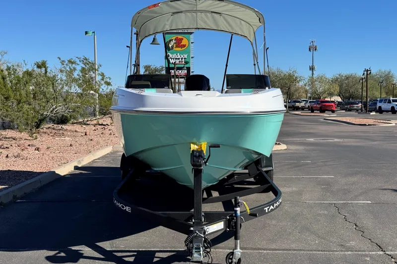 Slide: The Image of 2026 Tahoe T21 boat on trailer in parking lot, sunny day, outdoor setting. - 2