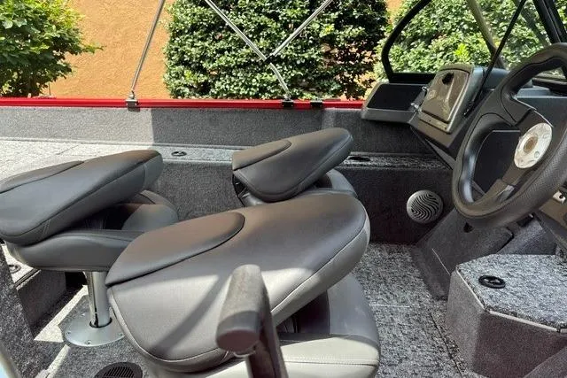 Slide: The Image of 2026 Tracker Pro Guide V-175 Combo boat interior with gray seating and steering wheel. - 6