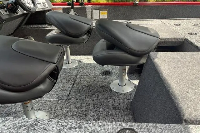 Slide: The Image of 2026 Tracker Pro Guide V-175 Combo boat interior with swivel seats and carpeted flooring. - 10
