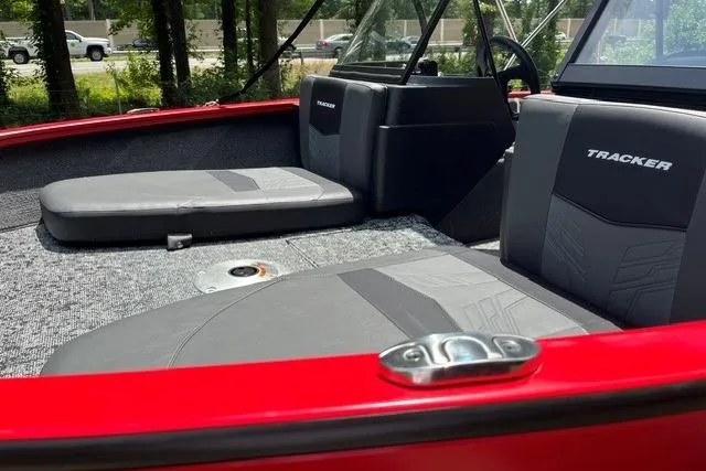 Slide: The Image of 2026 Tracker Pro Guide V-175 Combo boat interior with gray seating and red accents. - 13