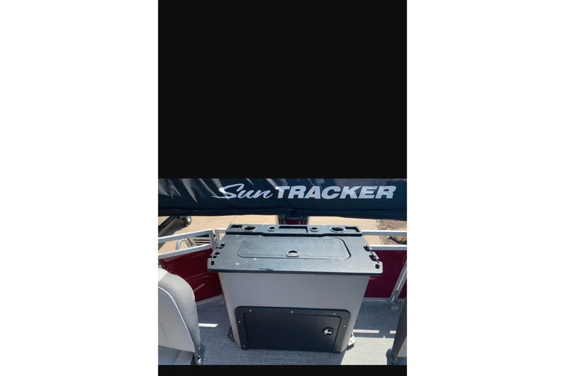 Slide: The Image of 2026 Sun Tracker SportFish 20 DLX boat interior with storage compartment and seating. - 88