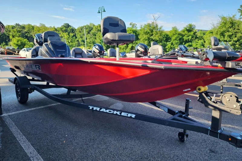 The Image of 2026 Tracker Pro Team 190 boat in vibrant red on a trailer, parked outdoors. - 0