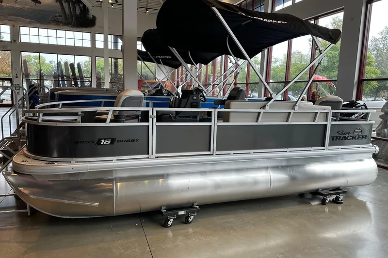 The Image of 2026 Sun Tracker Bass Buggy 18 DLX pontoon boat displayed indoors. - 0