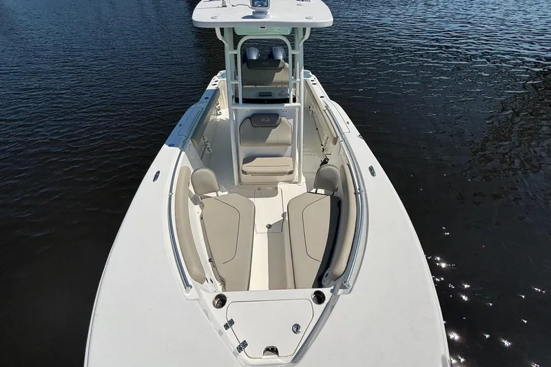 Slide: The Image of 2021 Key West 244 Center Console boat on calm water, showcasing spacious seating. - 13