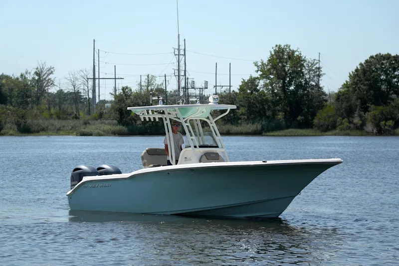 Slide: The Image of 2021 Key West 244 Center Console boat cruising on a calm lake. - 4