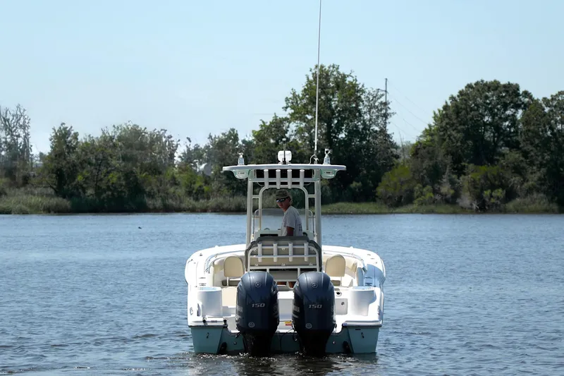Slide: The Image of 2021 Key West 244 Center Console boat on a calm lake with trees in the background. - 6