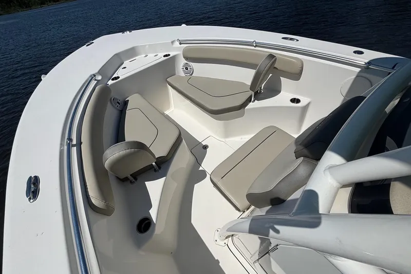 Slide: The Image of 2021 Key West 244 Center Console boat interior with cushioned seating on calm water. - 9