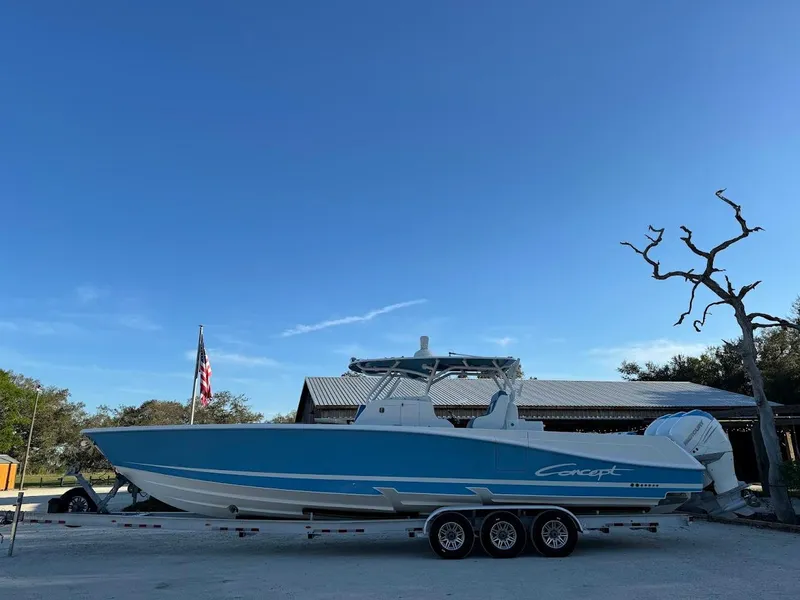 Slide: The Image of 2018 Concept 392 Family Edition boat on trailer, blue and white design, parked outdoors. - 1