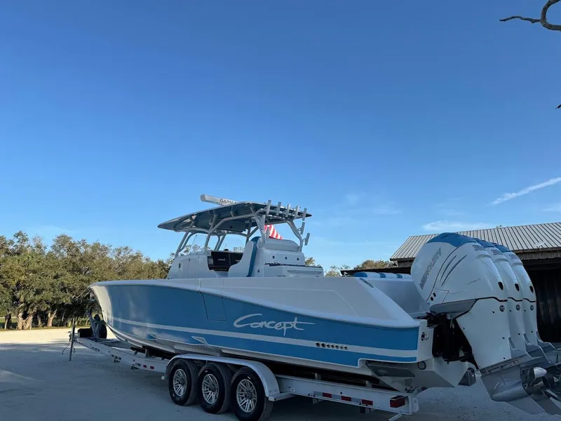 Slide: The Image of 2018 Concept 392 Family Edition boat on trailer, blue and white design, clear sky background. - 11