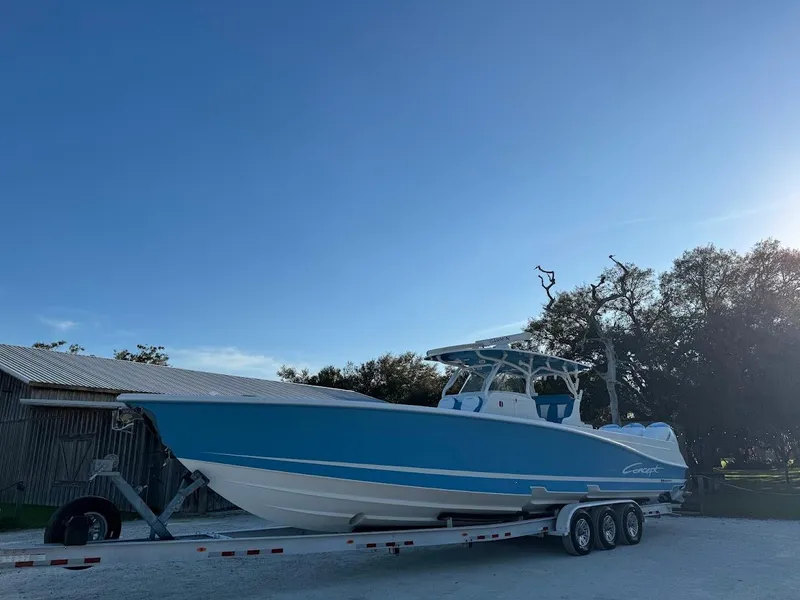 Slide: The Image of 2018 Concept 392 Family Edition boat on trailer under clear blue sky. - 2