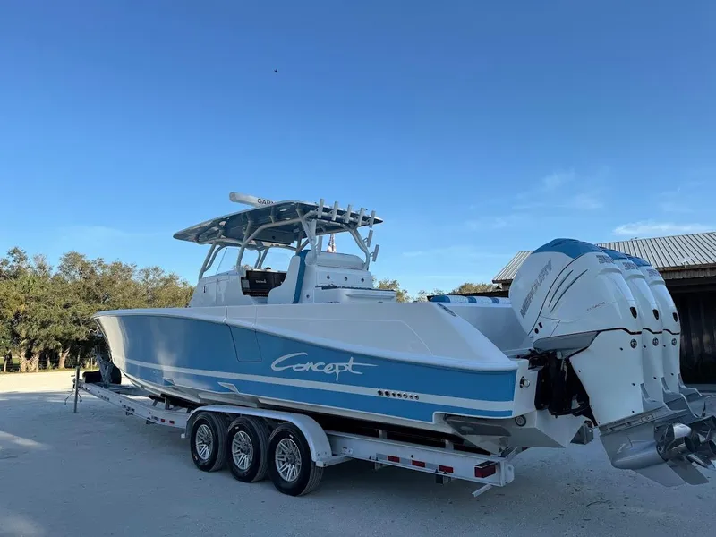 Slide: The Image of 2018 Concept 392 Family Edition boat on trailer, featuring triple outboard engines. - 4