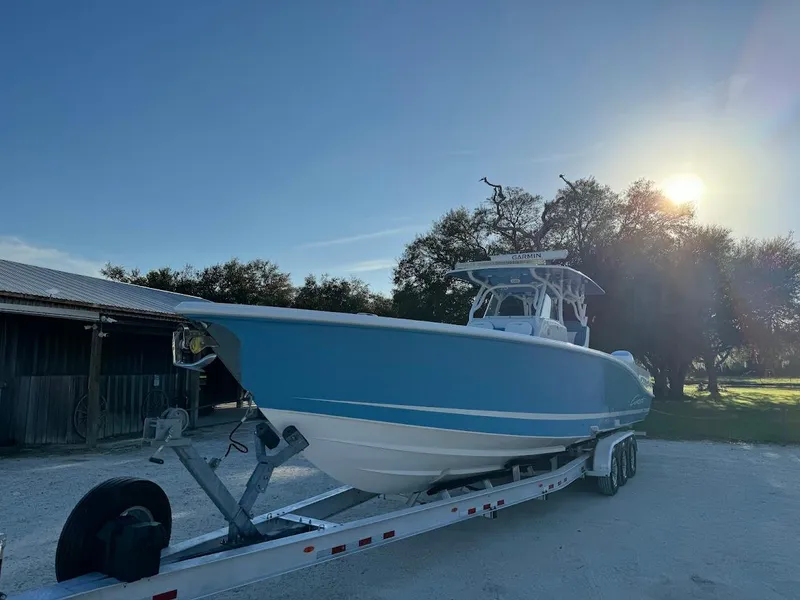 Slide: The Image of Concept 392 Family Edition 2018 boat on trailer, parked outdoors with sunlit background. - 9