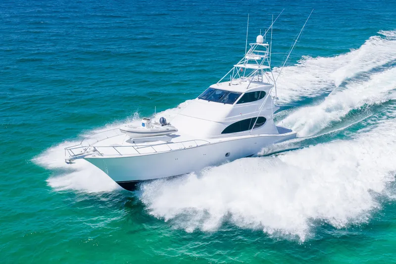 The Image of 2008 Hatteras 77 Convertible yacht cruising on open blue ocean waters. - 0