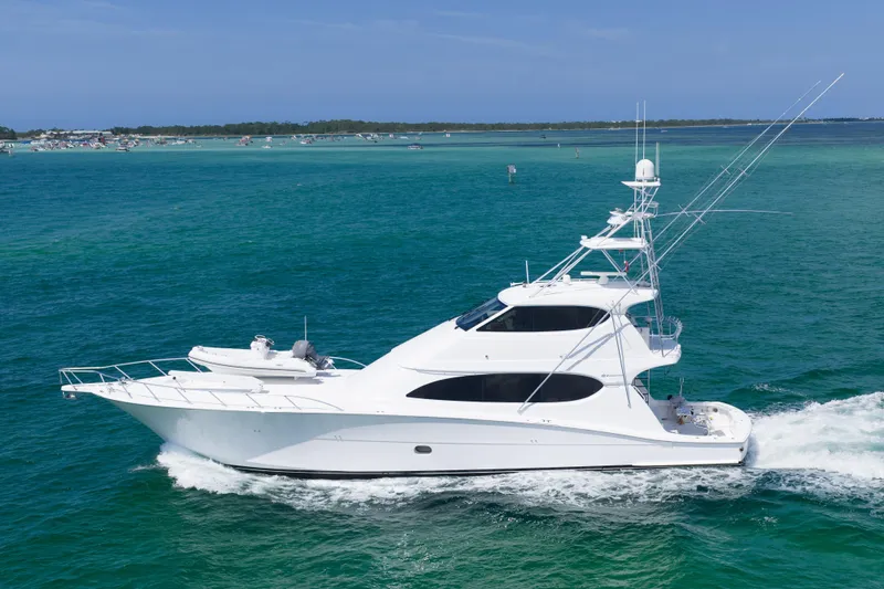Slide: The Image of Luxury 2008 Hatteras 77 Convertible yacht cruising on turquoise waters. - 1