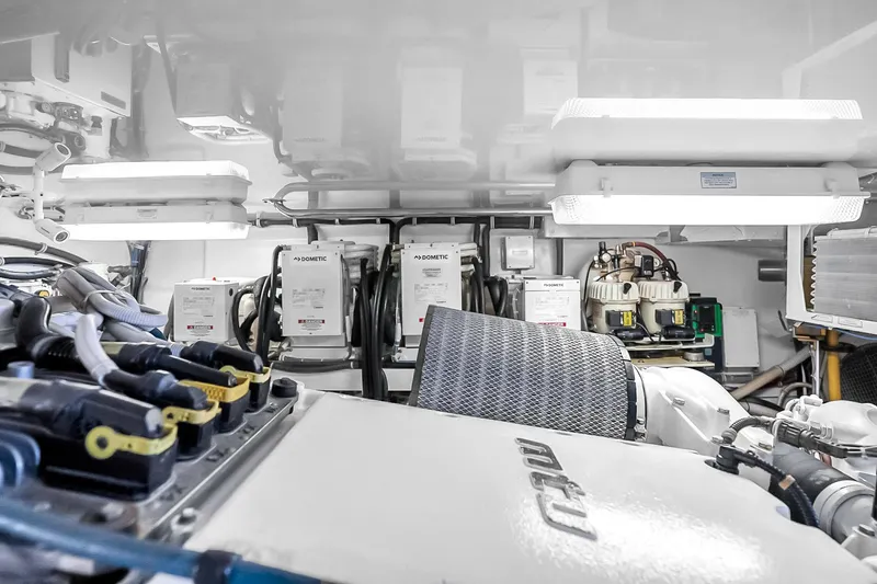 Slide: The Image of Engine room of 2008 Hatteras 77 Convertible yacht, featuring advanced machinery and equipment. - 100