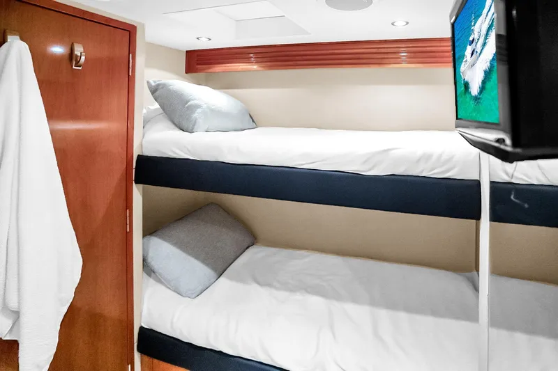 Slide: The Image of Interior of 2008 Hatteras 77 Convertible yacht with cozy bunk beds and wall-mounted TV. - 103