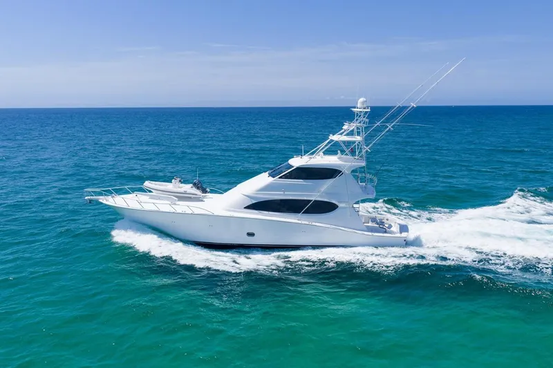 Slide: The Image of Luxury 2008 Hatteras 77 Convertible yacht cruising on open ocean waters. - 12