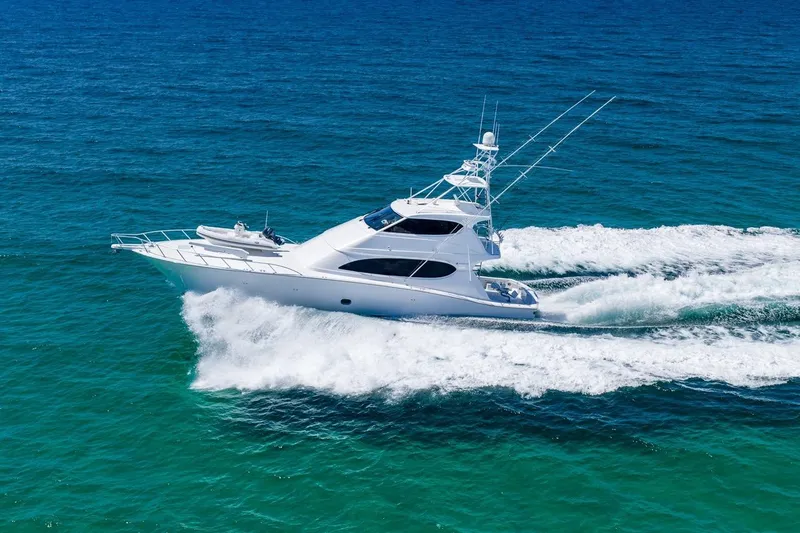 Slide: The Image of 2008 Hatteras 77 Convertible yacht cruising on open ocean waters. - 14