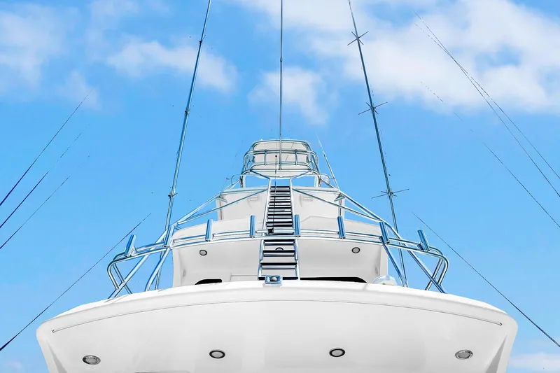 Slide: The Image of 2008 Hatteras 77 Convertible yacht against a clear blue sky. - 22