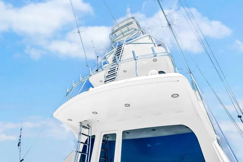 Slide: The Image of 2008 Hatteras 77 Convertible yacht against a clear blue sky. - 27