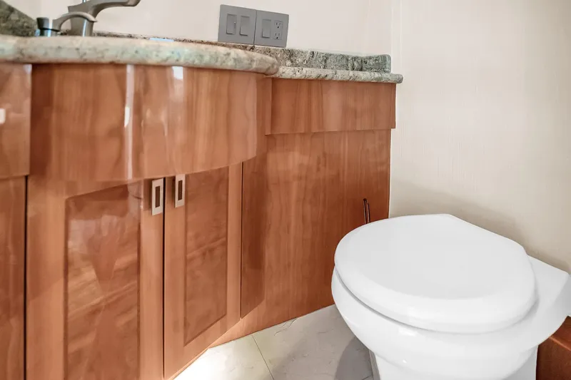 Slide: The Image of Luxurious bathroom interior of 2008 Hatteras 77 Convertible yacht with wooden cabinetry. - 30