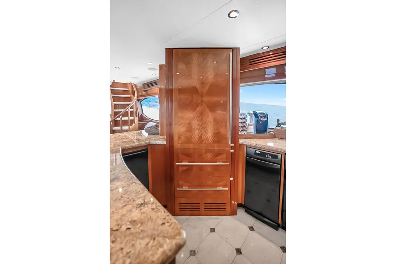 Slide: The Image of Luxurious kitchen interior of 2008 Hatteras 77 Convertible yacht with wooden cabinetry. - 35