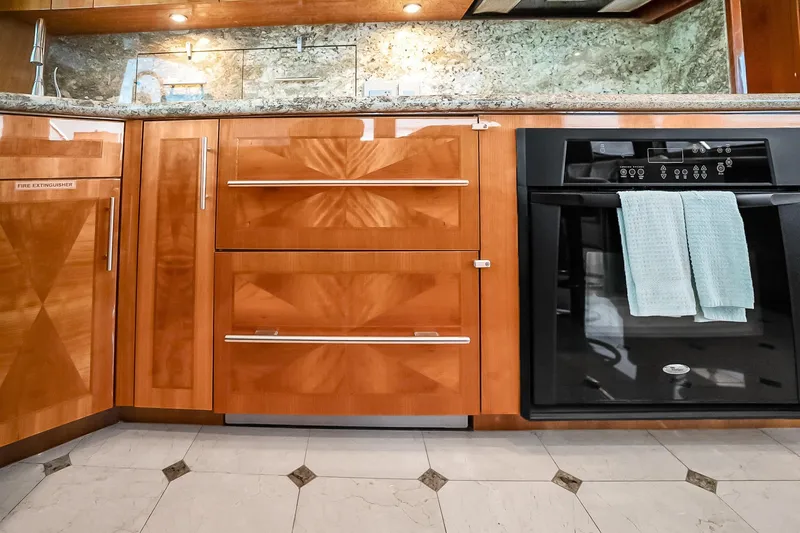 Slide: The Image of Luxurious kitchen interior of 2008 Hatteras 77 Convertible yacht with wood cabinetry and modern appliances. - 38