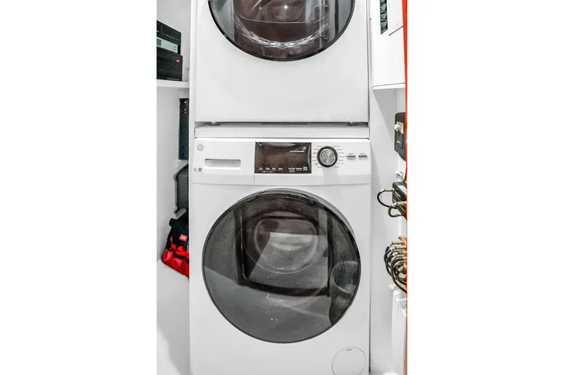 Slide: The Image of Stacked washer and dryer in 2008 Hatteras 77 Convertible yacht laundry area. - 45