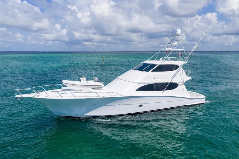 Slide: The Image of 2008 Hatteras 77 Convertible yacht on clear blue ocean waters. - 5