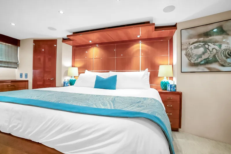 Slide: The Image of Luxurious bedroom interior on 2008 Hatteras 77 Convertible yacht, featuring elegant decor and lighting. - 53