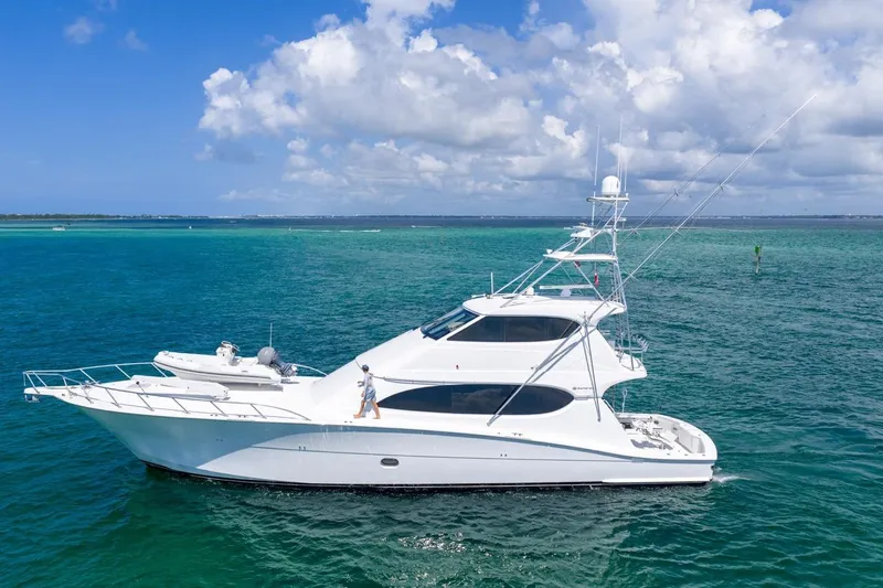 Slide: The Image of 2008 Hatteras 77 Convertible yacht cruising on clear blue ocean waters. - 6