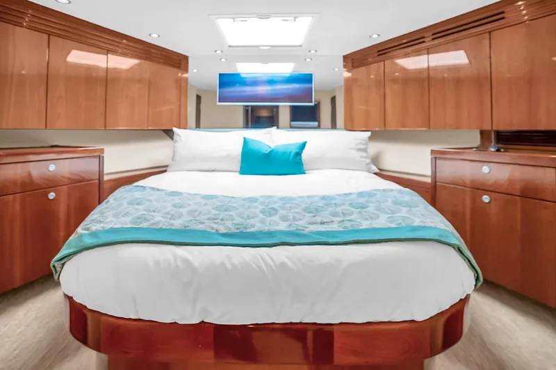 Slide: The Image of Luxurious bedroom interior of 2008 Hatteras 77 Convertible yacht with elegant wood cabinetry. - 64