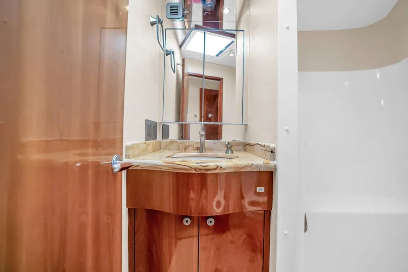 Slide: The Image of Luxurious bathroom interior of 2008 Hatteras 77 Convertible yacht with marble countertop. - 65