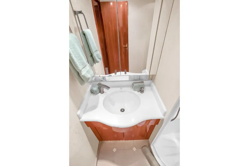 Slide: The Image of Luxurious bathroom in 2008 Hatteras 77 Convertible yacht with modern sink and mirror. - 76