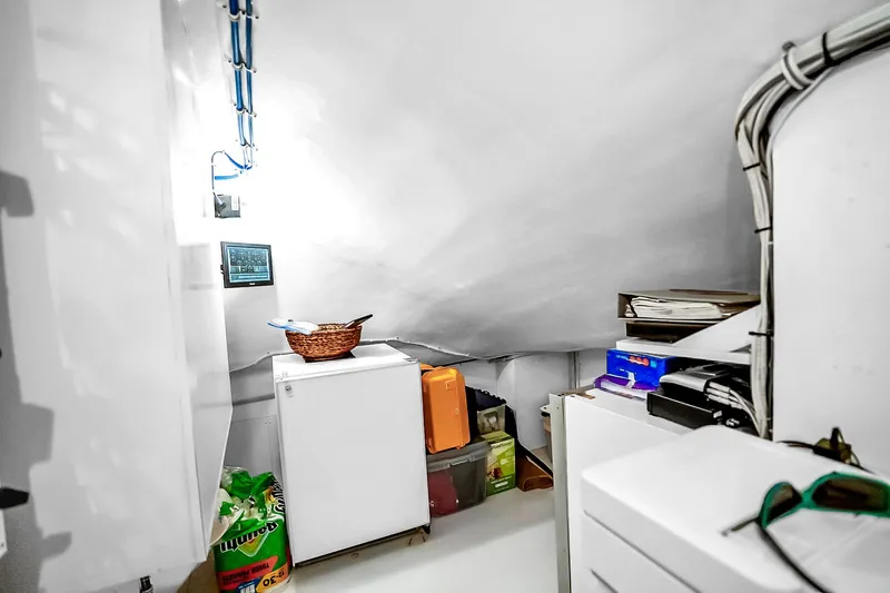 Slide: The Image of Storage area inside 2008 Hatteras 77 Convertible yacht with fridge and supplies. - 78