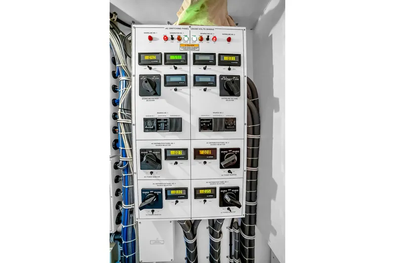 Slide: The Image of Electrical panel on 2008 Hatteras 77 Convertible yacht, featuring gauges and switches. - 79