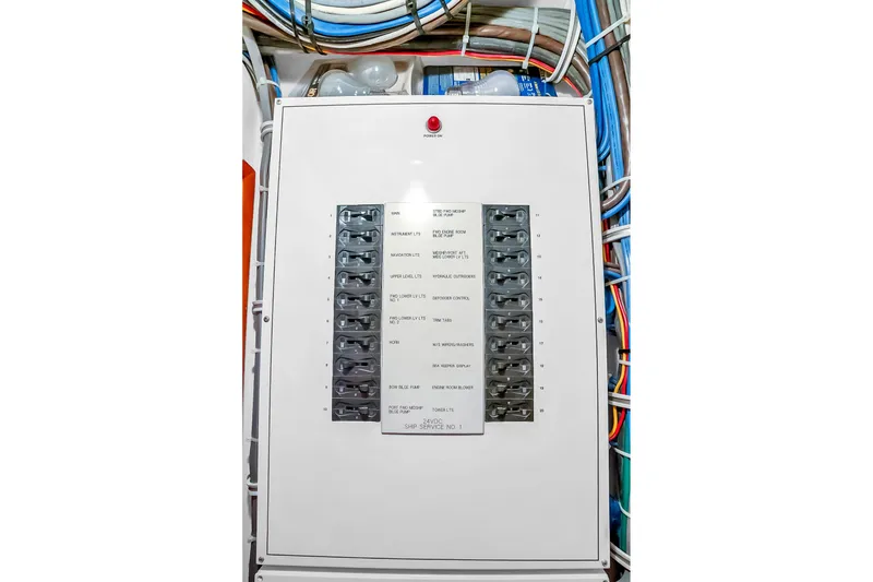 Slide: The Image of Electrical panel on 2008 Hatteras 77 Convertible yacht with labeled switches and wiring. - 80