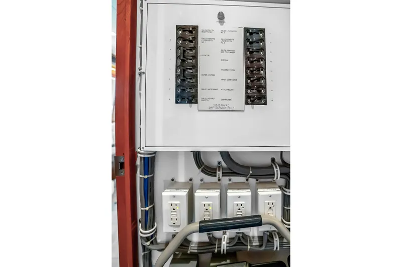 Slide: The Image of Electrical panel and outlets on a 2008 Hatteras 77 Convertible yacht. - 81