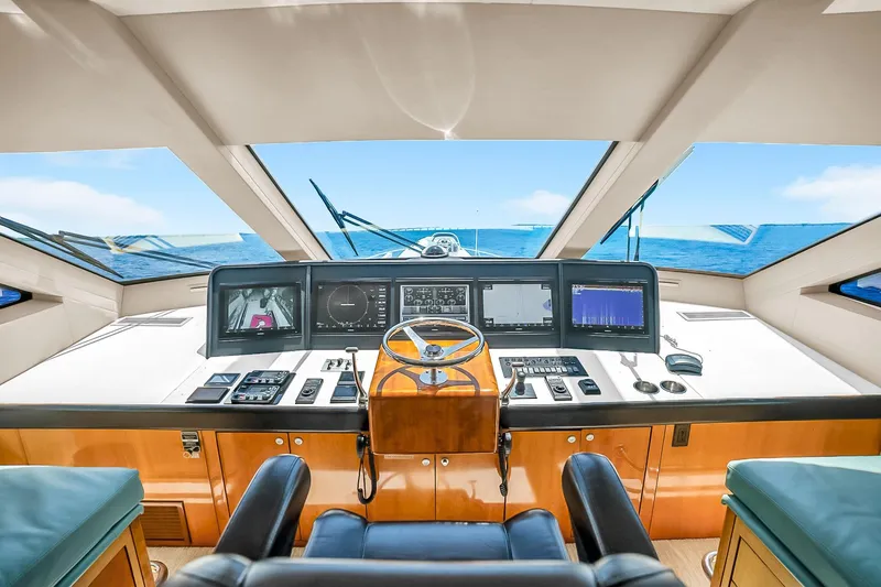 Slide: The Image of Helm of 2008 Hatteras 77 Convertible yacht with modern navigation equipment and ocean view. - 84